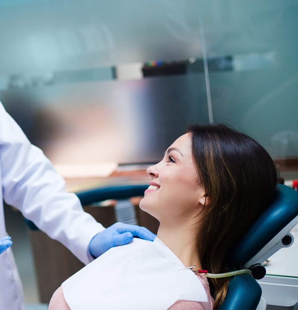 Very nice lady smiling looking up at doctor while doctor puts his hand on her shoulder