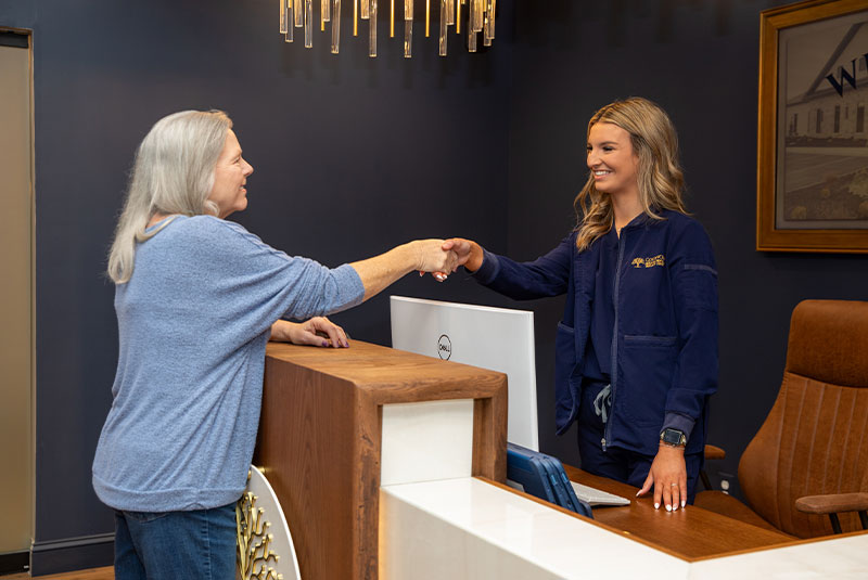 patient and staff member going over dental procedure information within the dental center