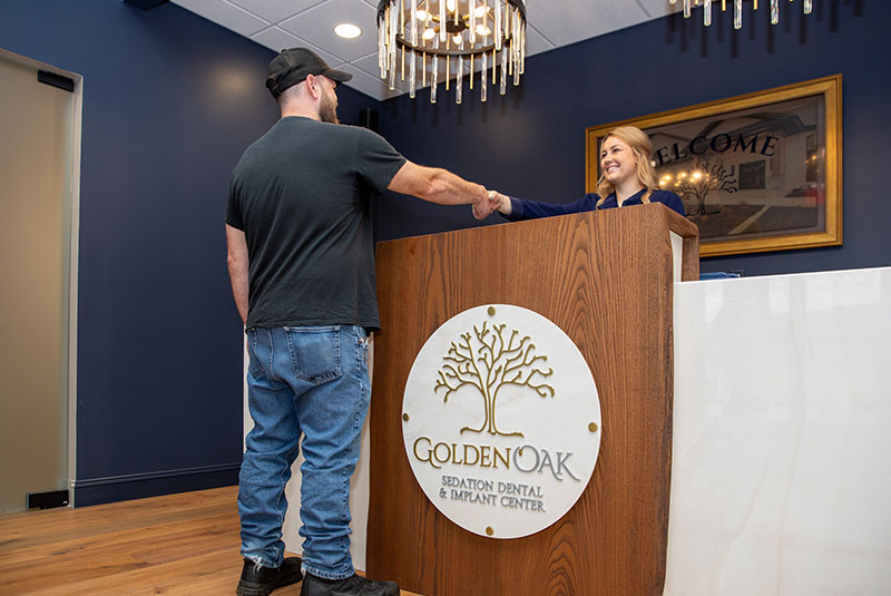 Team member checking in Patient to dental office