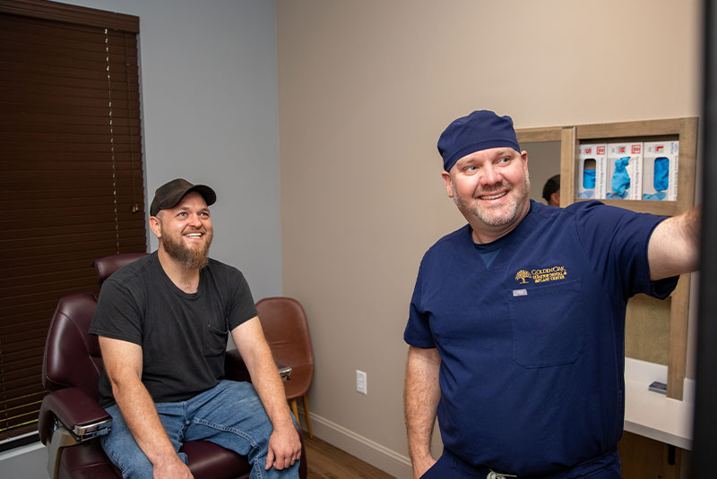Doctor going over dental x-ray With Patient