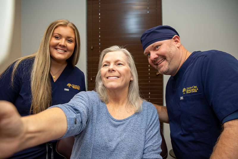 Doctor and Patient looking into mirror smiling