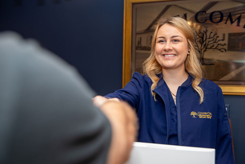 Team member greeting Patient into dental office