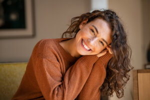 women smiling at the camera in a dental office
